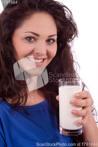 Image of beautiful smiling woman is drinking milk