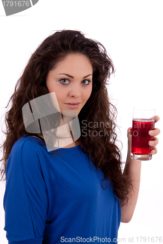 Image of beautiful smiling brunette woman is drinking red juice