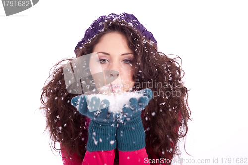 Image of beautiful smiling brunette woman in snow in winter 