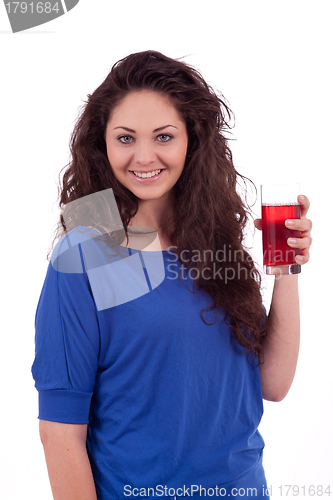 Image of beautiful smiling brunette woman is drinking red juice