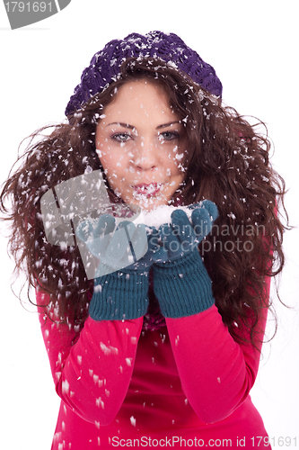Image of beautiful smiling brunette woman in snow in winter 
