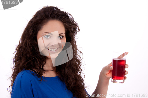 Image of beautiful smiling brunette woman is drinking red juice