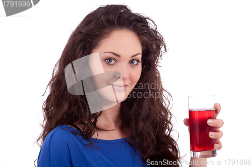 Image of beautiful smiling brunette woman is drinking red juice