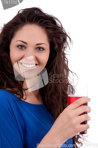 Image of beautiful smiling brunette woman is drinking red juice