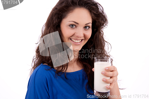 Image of beautiful smiling woman is drinking milk