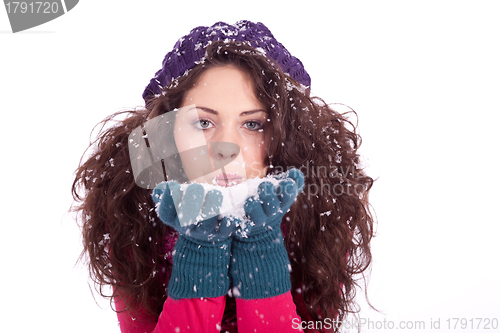 Image of beautiful smiling brunette woman in snow in winter 