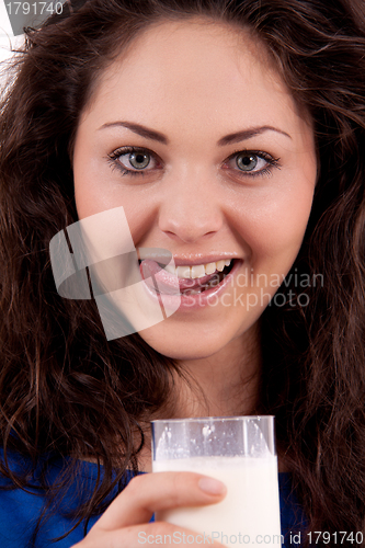 Image of beautiful smiling woman is drinking milk