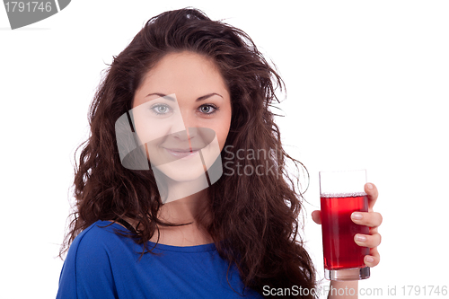 Image of beautiful smiling brunette woman is drinking red juice