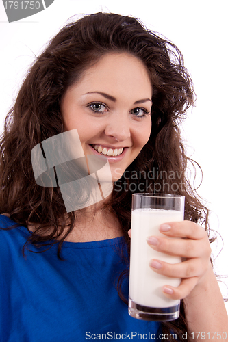 Image of beautiful smiling woman is drinking milk