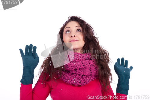 Image of beautiful smiling brunette woman in snow in winter 