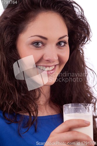 Image of beautiful smiling woman is drinking milk