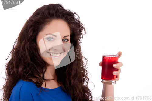 Image of beautiful smiling brunette woman is drinking red juice