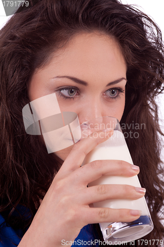 Image of beautiful smiling woman is drinking milk