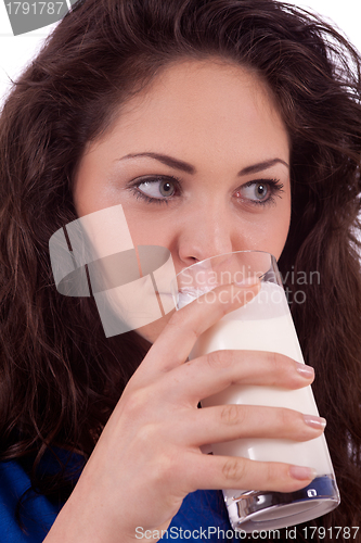 Image of beautiful smiling woman is drinking milk
