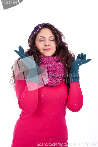 Image of beautiful smiling brunette woman in snow in winter 