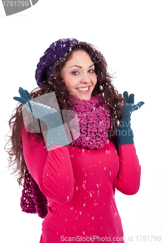 Image of beautiful smiling brunette woman in snow in winter 