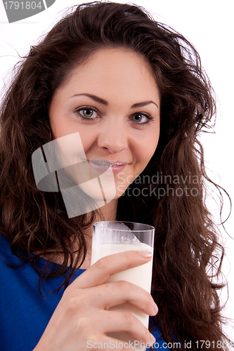 Image of beautiful smiling woman is drinking milk
