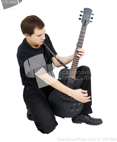 Image of young singer, dressed in black with an electric guitar