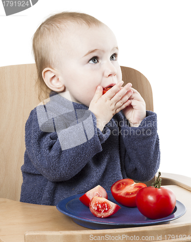Image of young child eating in high chair