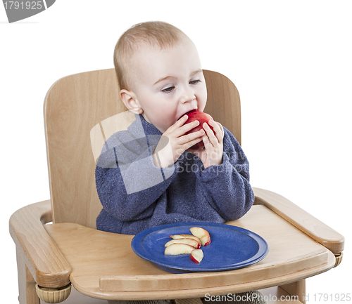 Image of young child eating peaches in high chair