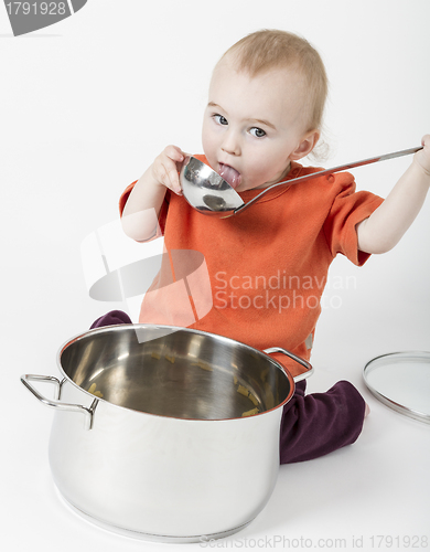 Image of baby with big cooking pot