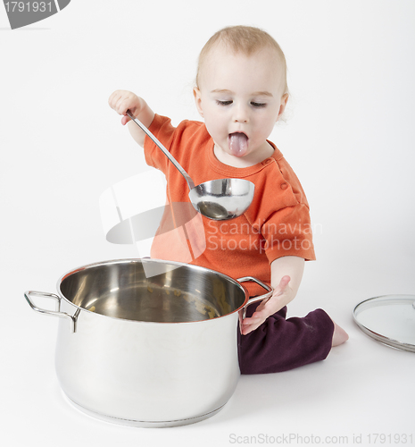 Image of baby with big cooking pot