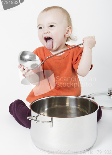 Image of baby with big cooking pot