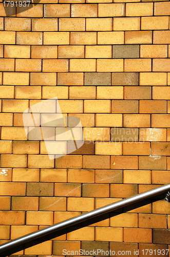 Image of Background yellow brick wall steel stair railing 