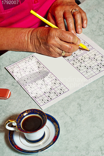 Image of pensioner with sudoku