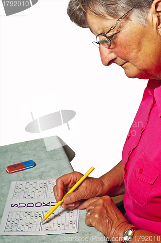 Image of pensioner with sudoku