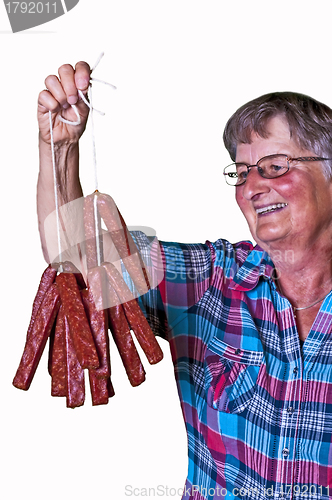 Image of female butcher with smoked sausage