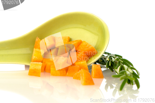 Image of Green ceramic spoon with carrot pieces