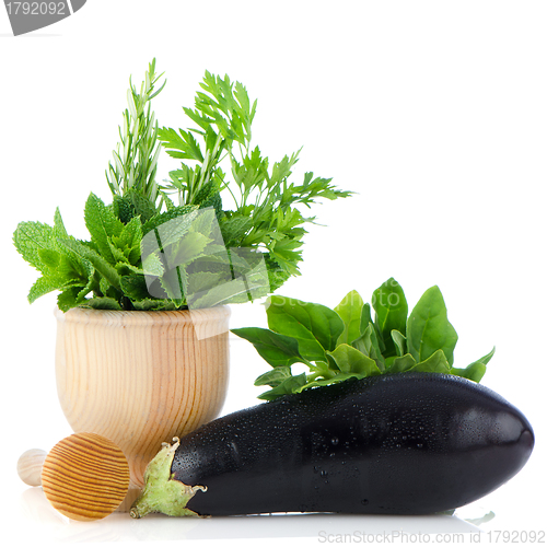 Image of Eggplant and green herb leafs 