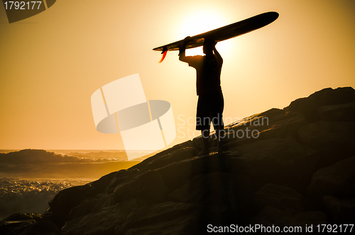 Image of Long boarder watching the waves