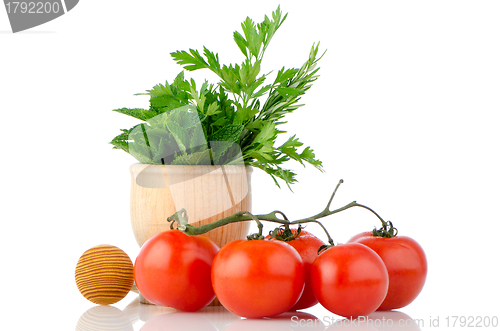 Image of Tomatoes and green herb leafs 