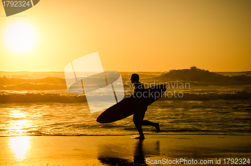 Image of Surfer running