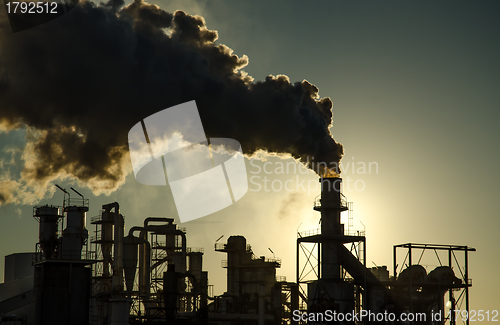 Image of Smoking chimney  at sunset 