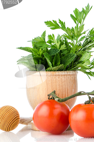 Image of Tomatoes and green herb leafs 
