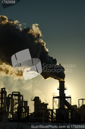 Image of Smoking chimney  at sunset 