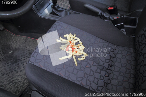Image of French fries on a car seat