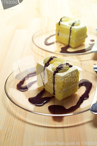 Image of fresh cream cake closeup with chocolate sauce