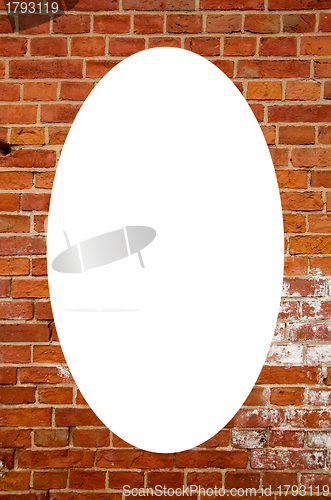 Image of Red brick wall and white oval in center 