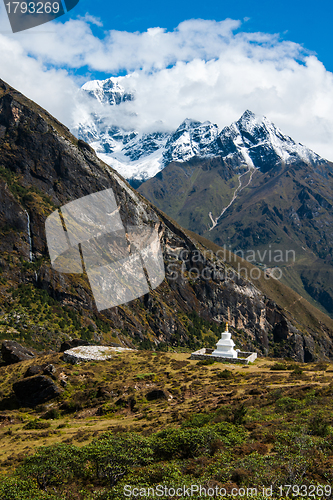 Image of Buddhist stupe or chorten and summits in Himalayas