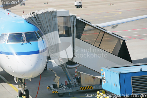 Image of Airplane at an airport with passenger gangway 