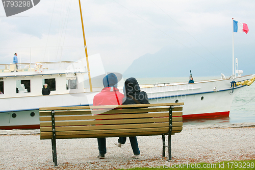 Image of Couple watching boat on the winter