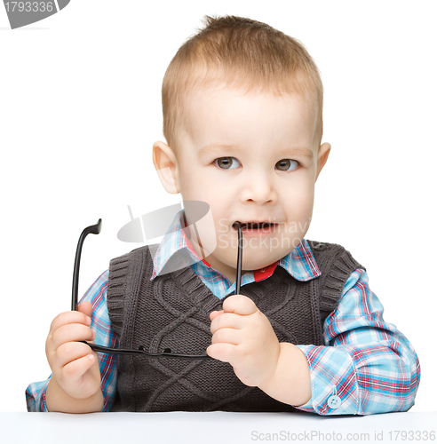 Image of Cute little child play with book