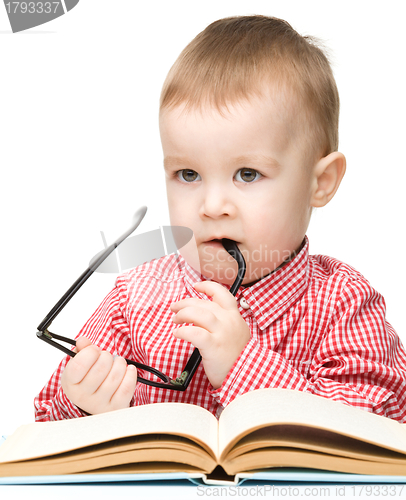 Image of Cute little child play with book