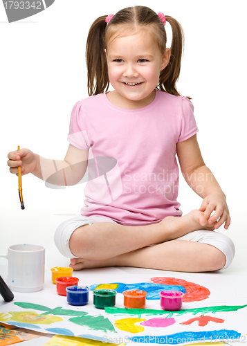 Image of Cute cheerful child play with paints