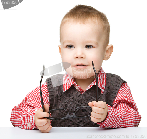 Image of Portrait of a cute little boy wearing glasses