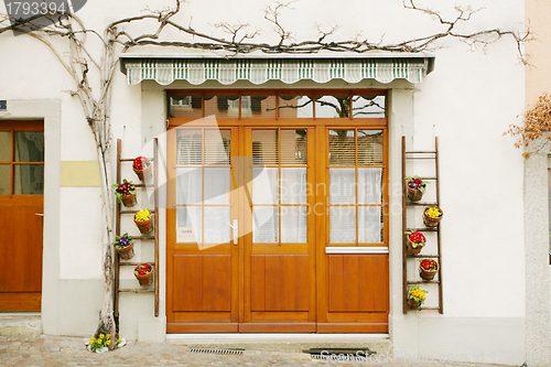 Image of house door and huge flower jar, Lausanne, Switzerland